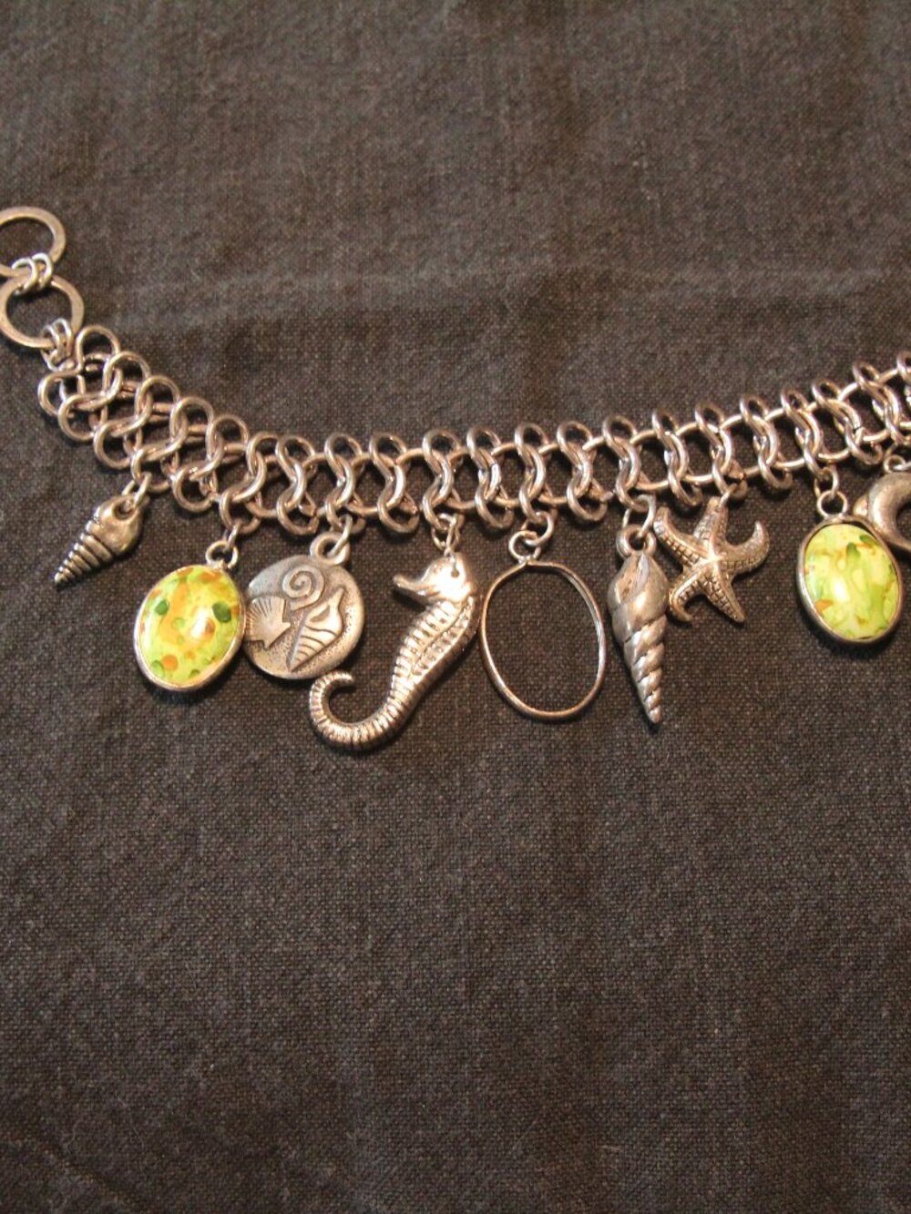 Seashore silver tone charm bracelet. Good condition.